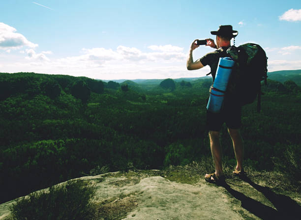 istock Backpacker man taking selfie picture use smartphone during hike 1185411562