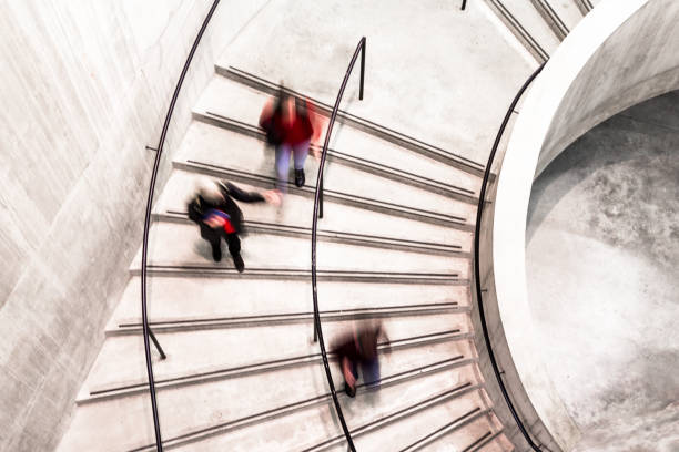 istock Blurred Motion of Urban People on Spiral Staircase 1185411936