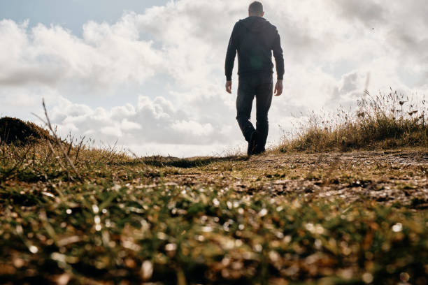 istock Man walking along the Cornish Coastline on a September day. 1185411975
