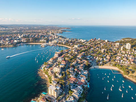 Aerial drone evening view of Manly, a beach-side suburb of northern Sydney in the state of New South Wales, Australia. Little Manly Beach in the foreground, Manly Harbour & Manly Beach in background.