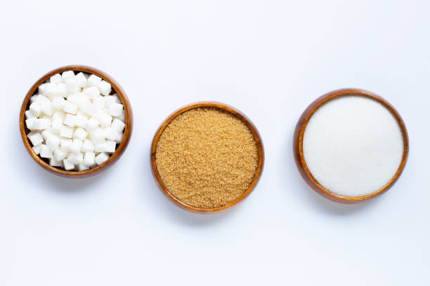 istock Wooden bowl with sugar on white background. 1185413540