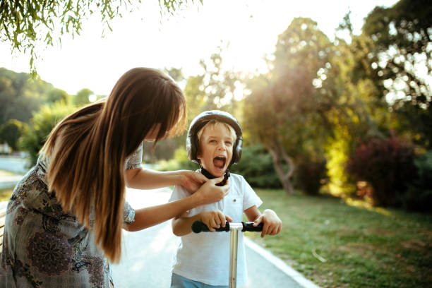 istock Cute little boy playing outside with his mom. 1185414172