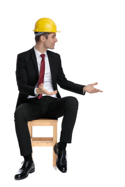 istock Young businessman looking away, exlplainign and talking 1185414814