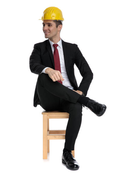 istock Interested businessman looking away while wearing a construction helmet, 1185414844