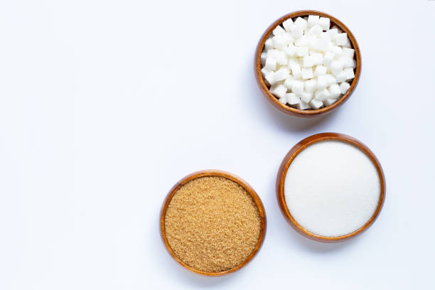 istock Wooden bowl with sugar on white background. Copy space 1185414903