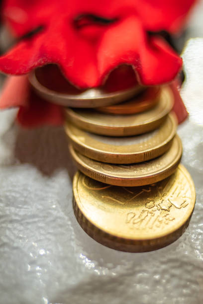 istock Gold shiny coins lie on a glass table 1185416852
