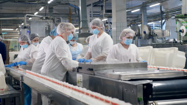 Alimentary factory unit with the staff relocating crab sticks