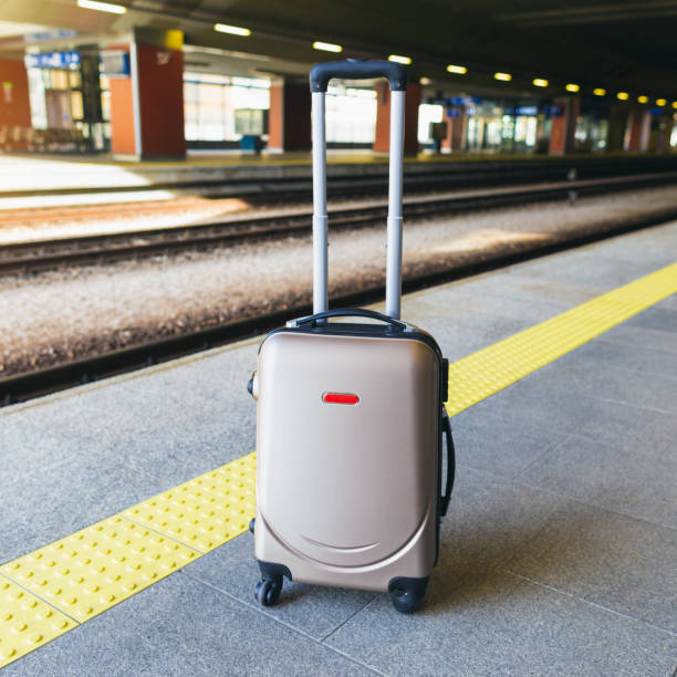 istock Suitcase on platform of the railway station 1185416885