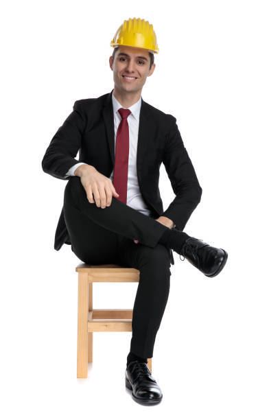 istock Cheerful businessman looking forward while wearing a construction helmet 1185417279