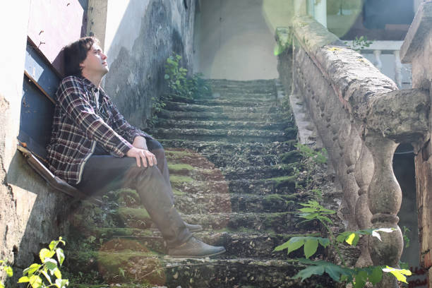 istock man sit on abandoned stair 1185418250