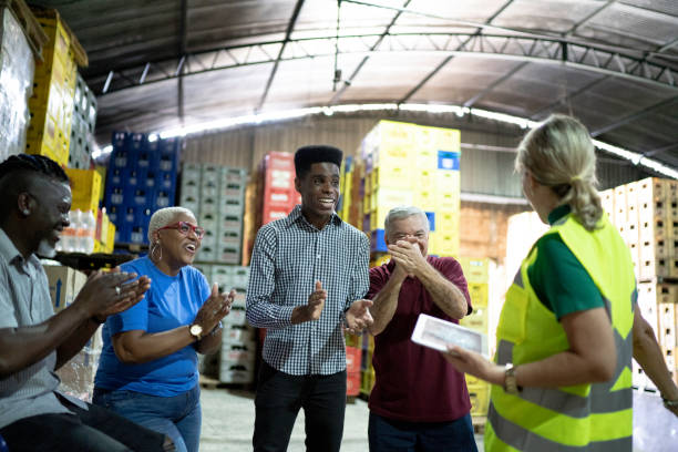istock Happy employees celebrating together at warehouse 1185418517