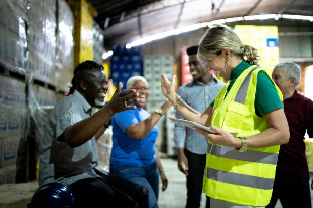 istock Happy employees celebrating together at warehouse 1185419185