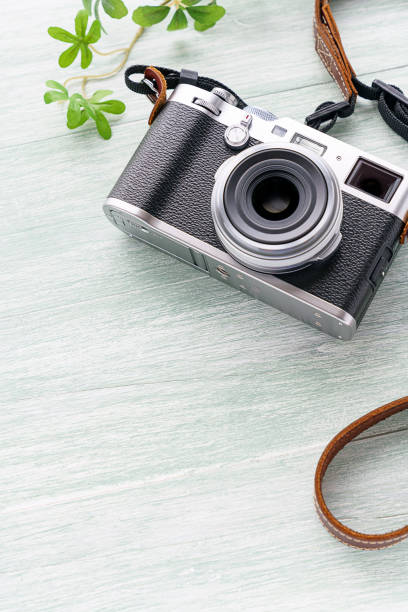 istock Old style digital cameras isolated on wooden background 1185419634