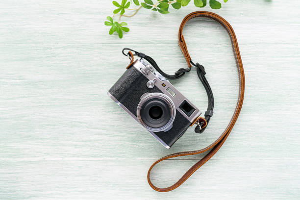 istock Old style digital cameras isolated on wooden background 1185419645