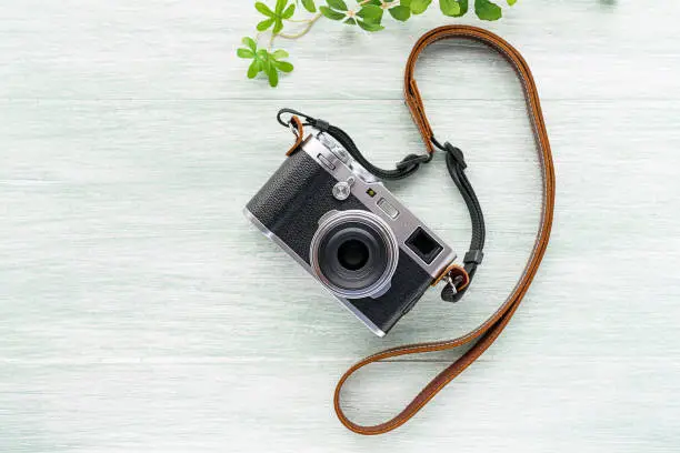 Old style digital cameras isolated on wooden background