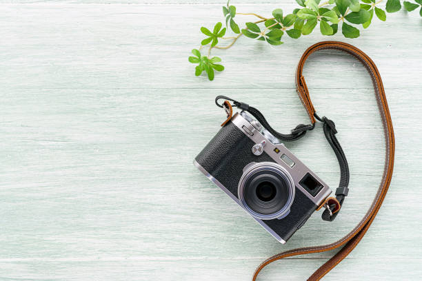 istock Old style digital cameras isolated on wooden background 1185419677