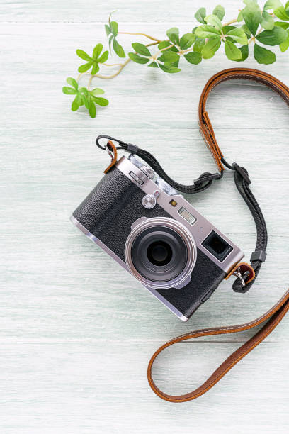 istock Old style digital cameras isolated on wooden background 1185419696