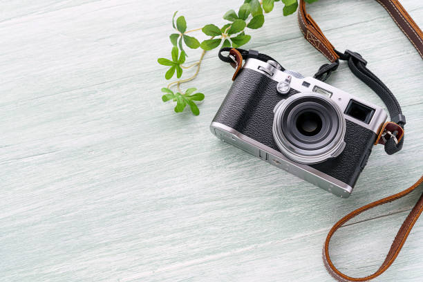 istock Old style digital cameras isolated on wooden background 1185419712