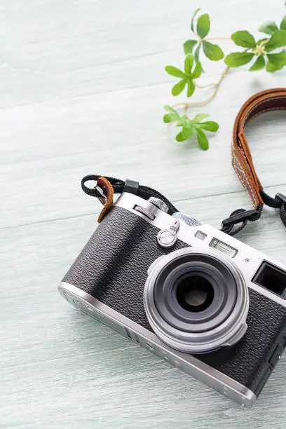 Old style digital cameras isolated on wooden background