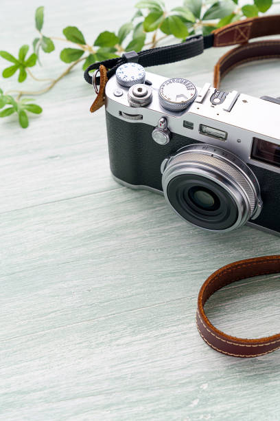 istock Old style digital cameras isolated on wooden background 1185419777