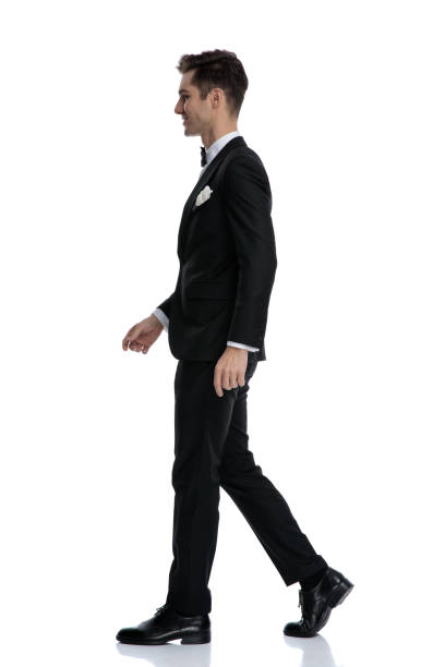 istock side view of young elegant man smiling and walking 1185419797