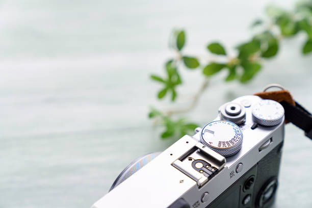 istock Old style digital cameras isolated on wooden background 1185419809