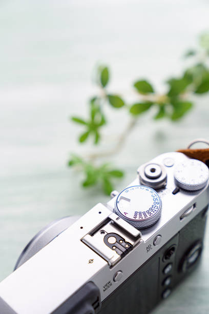 istock Old style digital cameras isolated on wooden background 1185419823