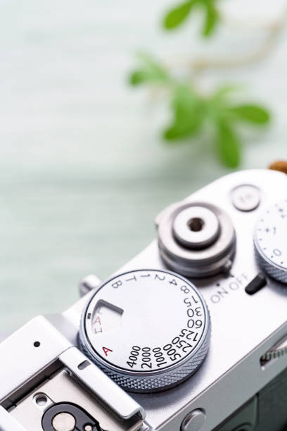istock Old style digital cameras isolated on wooden background 1185419881