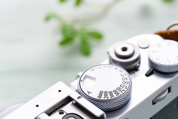 istock Old style digital cameras isolated on wooden background 1185419892
