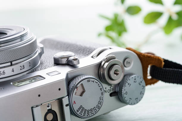 istock Old style digital cameras isolated on wooden background 1185419904