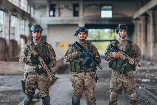 istock Army men standing in abandoned warehouse 1185419921