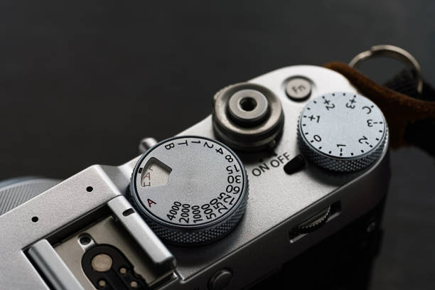 istock Old style digital cameras isolated on wooden background 1185419927