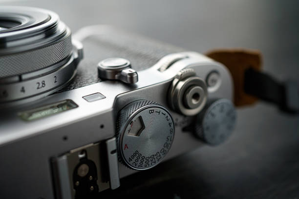 istock Old style digital cameras isolated on wooden background 1185420565