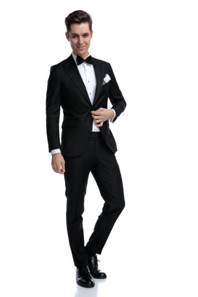 istock happy young man arranging coat and walking on white background 1185420574