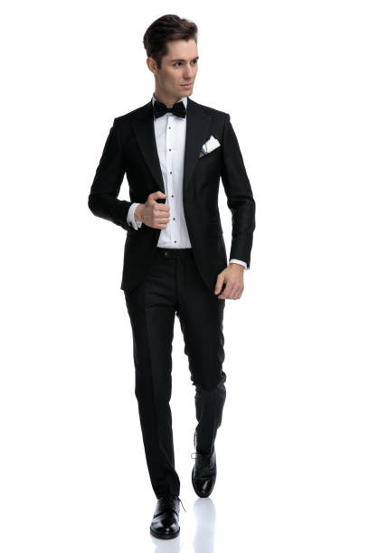 istock elegant young man walking and looking to side 1185420899