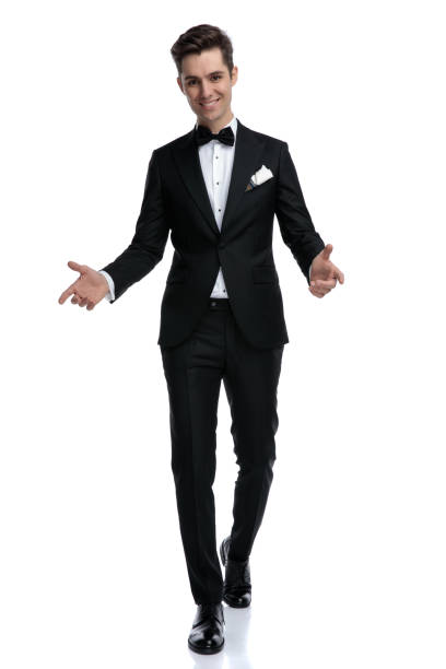 istock smiling young elegant groom walking and greeting 1185420959