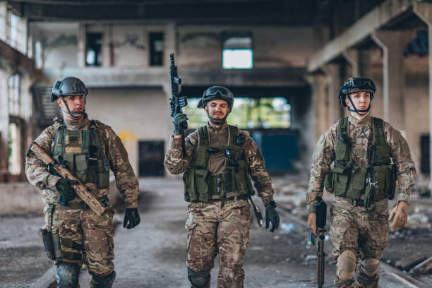 istock Soldiers walking in abandoned warehouse 1185421158