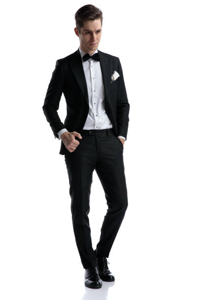 istock young elegant groom wearing tuxedo and looking to side 1185421228