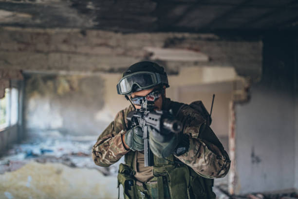 istock Military man on a mission in abandoned building 1185421278