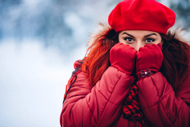 Portrait of a young beautiful woman in the snow.