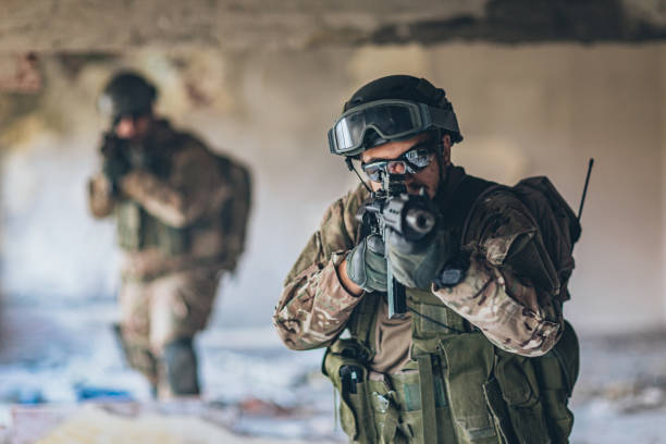 istock Two soldiers on a mission in abandoned building 1185421429