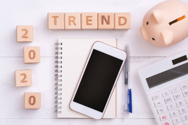 istock 2020 goal, finance plan abstract design concept, wood blocks on white table background with piggy bank, cell phone. 1185422513