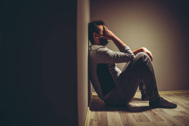 Depressive man Young depressed man sitting on floor. exhaustion photos stock pictures, royalty-free photos & images