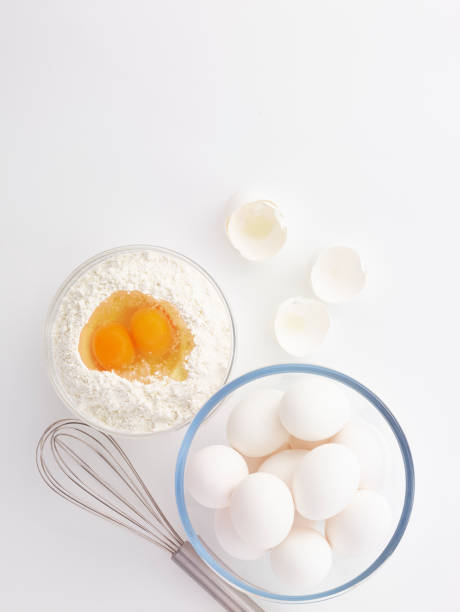 eggs, whisk, flour and rolling pin in the white background