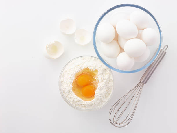 istock eggs, whisk, flour and rolling pin in the white background 1185424045