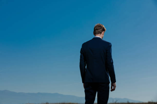 istock Back view of an upset businessman looking down 1185424689