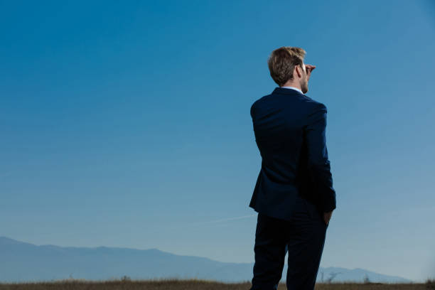 istock Back view of an eager businessman looking away 1185425493