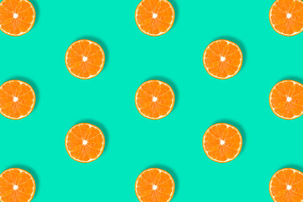 istock Fruit pattern of fresh mandarin slices on blue background. 1185425871