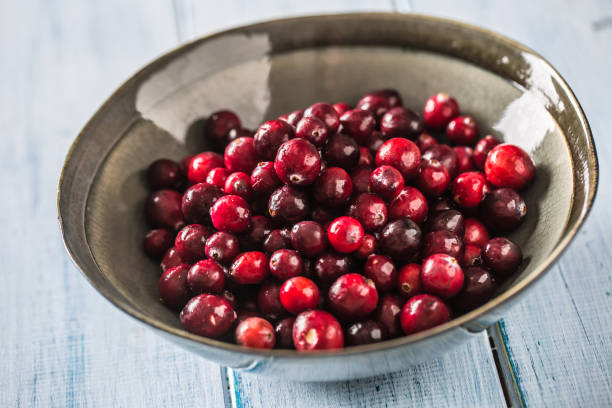istock Fresh ripe cranberries in bowl on table close-up 1185425963