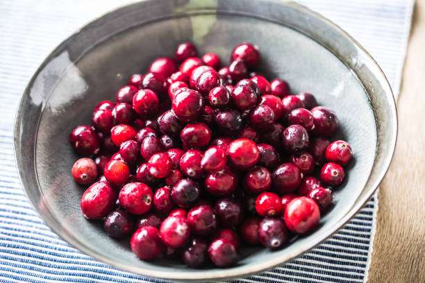 istock Fresh ripe cranberries in bowl on table close-up 1185425981